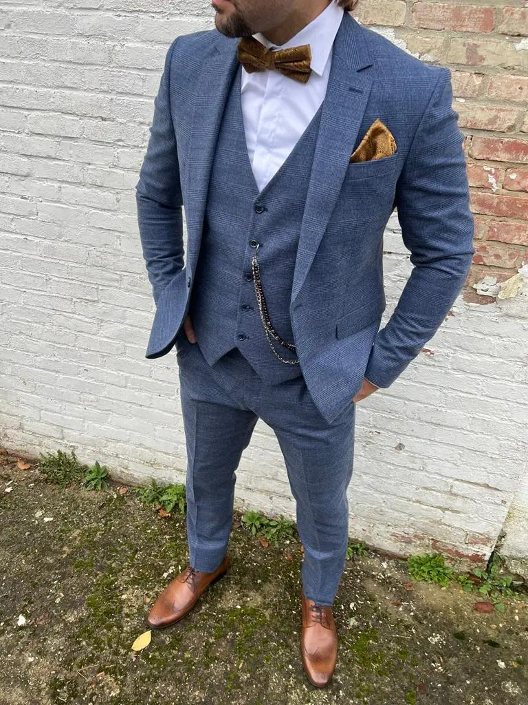 Homme en costume bleu avec nœud papillon marron
